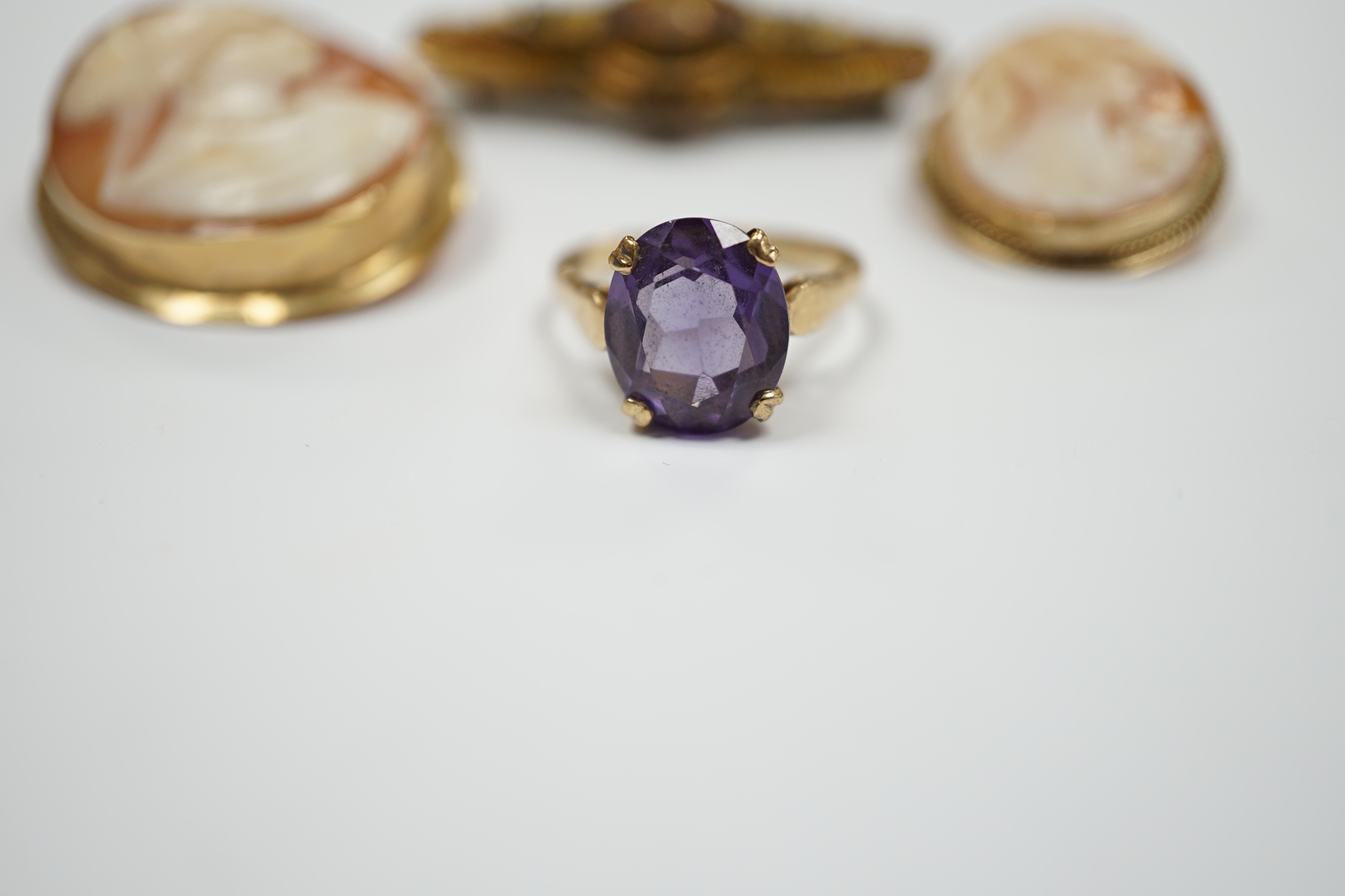 Two 9ct mounted oval cameo shell brooches, largest 38mm, a 9ct and gem set ring and a 9ct gold and gem set bar brooch.